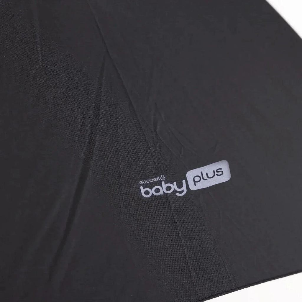 Black parasol fabric with "baby plus" logo patch on the canopy