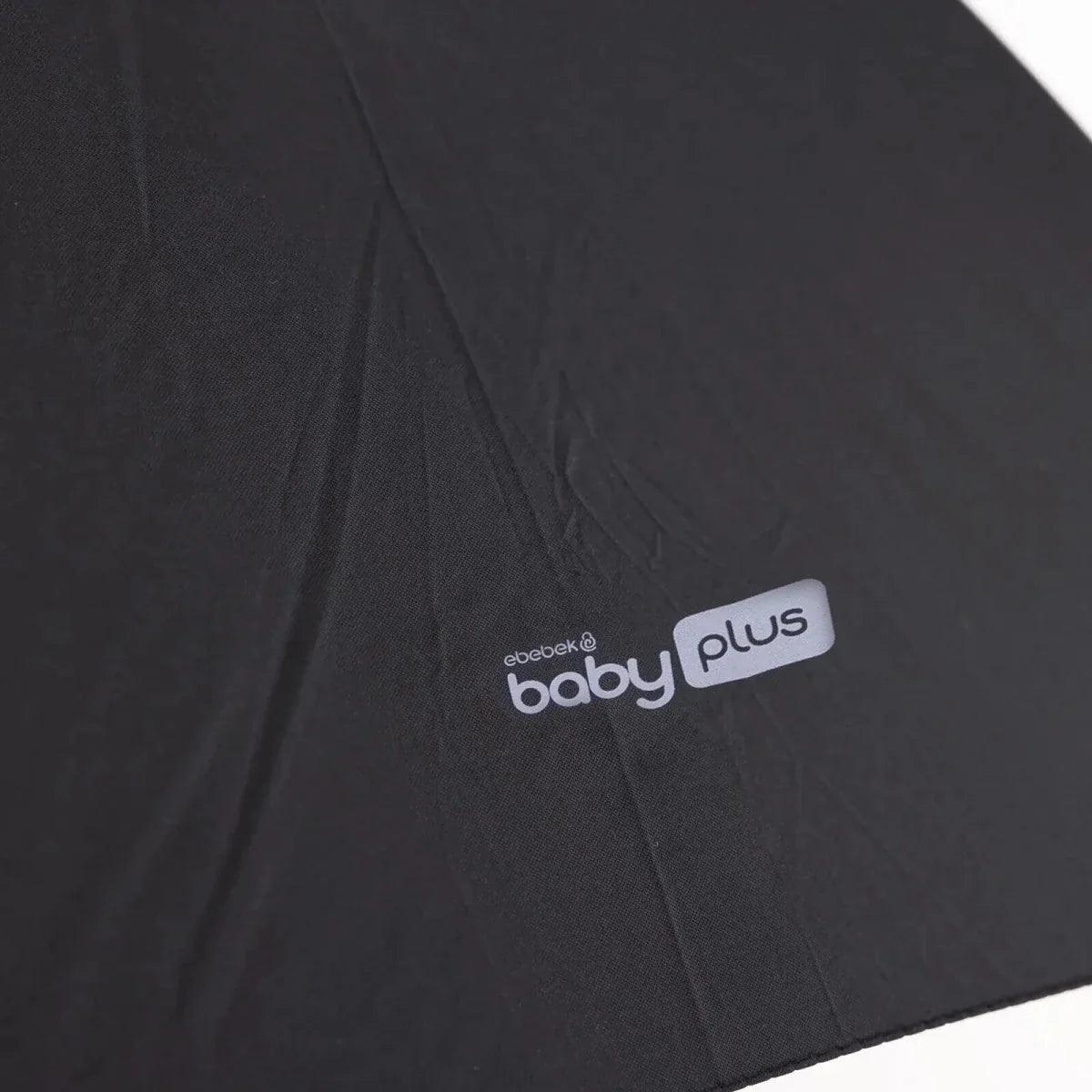 Black parasol fabric with "baby plus" logo patch on the canopy