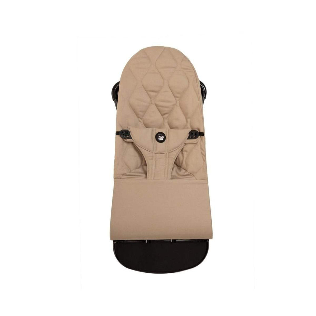 Beige baby bouncer with padded headrest and front harness, black semicircle base