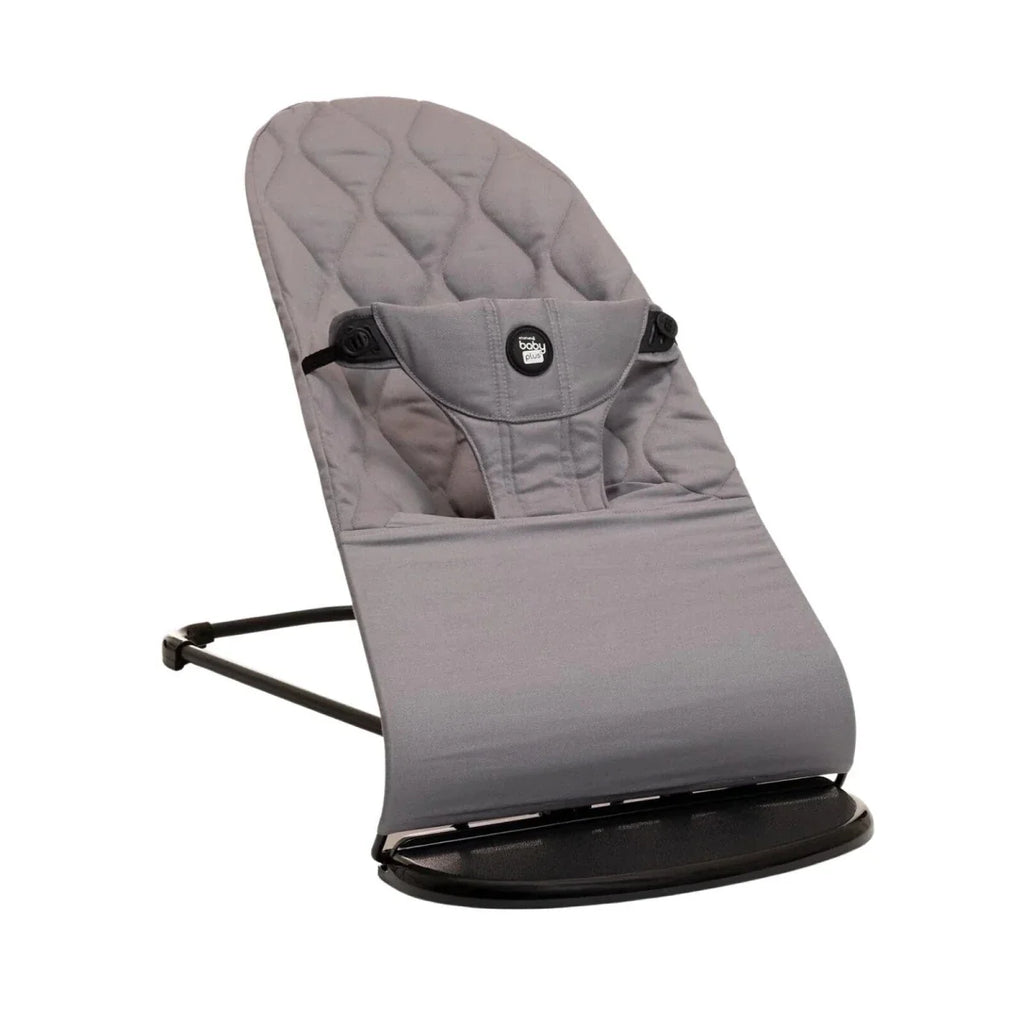 Grey fabric baby bouncer with quilted seat and arched rocker base