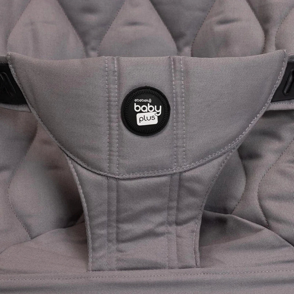 Grey baby bouncer harness with central logo patch on quilted seat