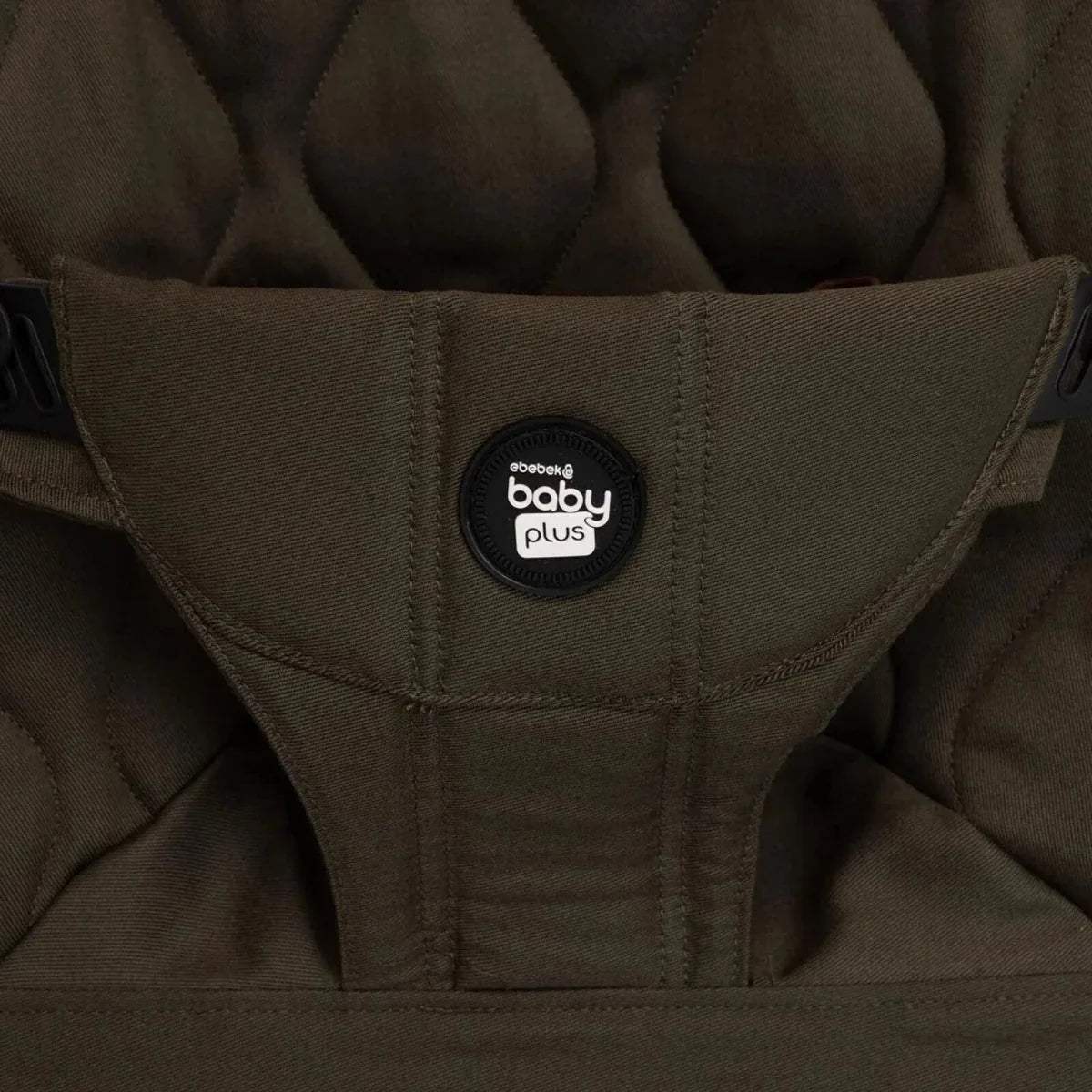 Khaki baby bouncer seat cover with “baby plus” logo patch and stitched harness.