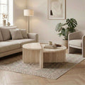 Modern round coffee table with travertine-look tabletop and deep oud wood frame