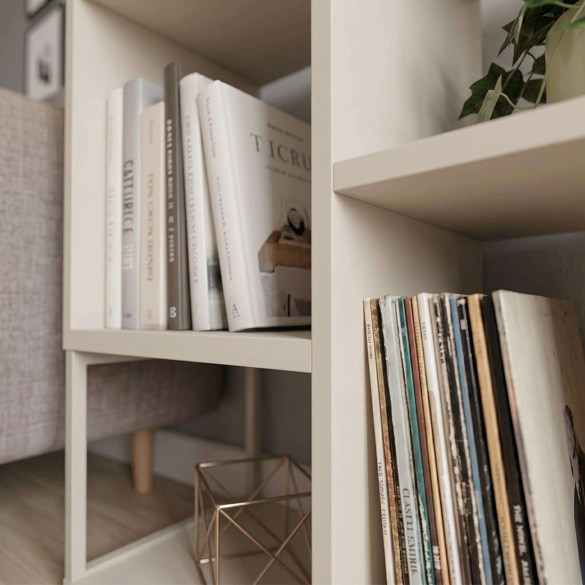 Close-up of light interior shelves in a mini bookcase side table with books
