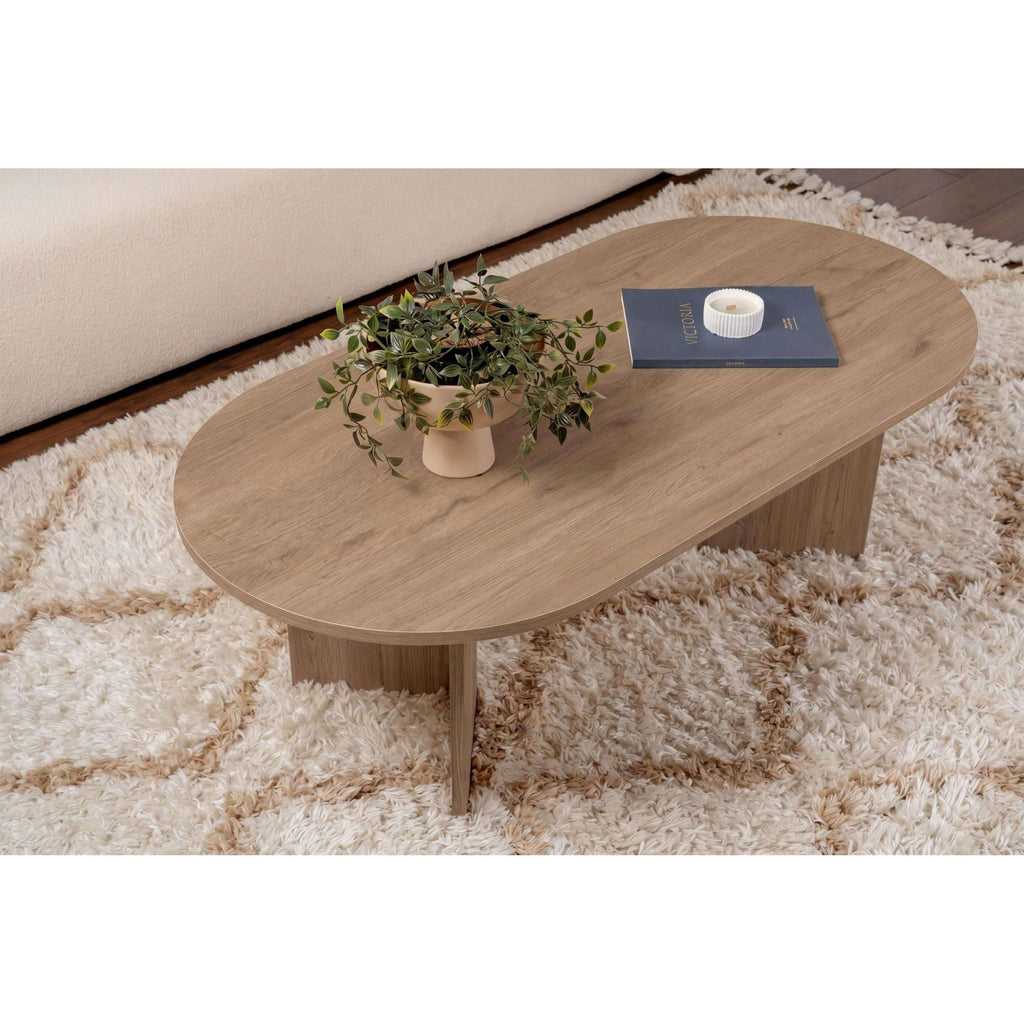 Oak oval coffee table with curved edge tabletop and central support leg.