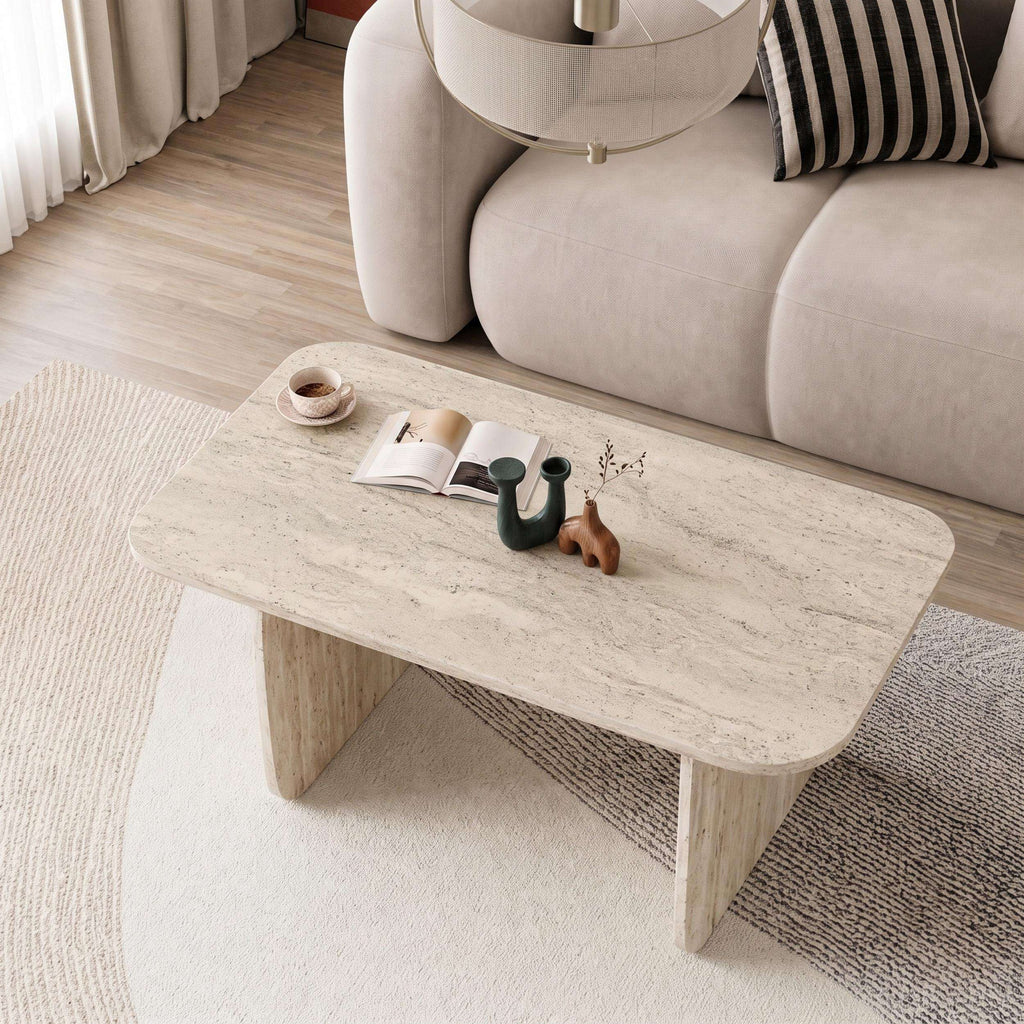 Rectangular travertine coffee table with rounded edges and thick legs