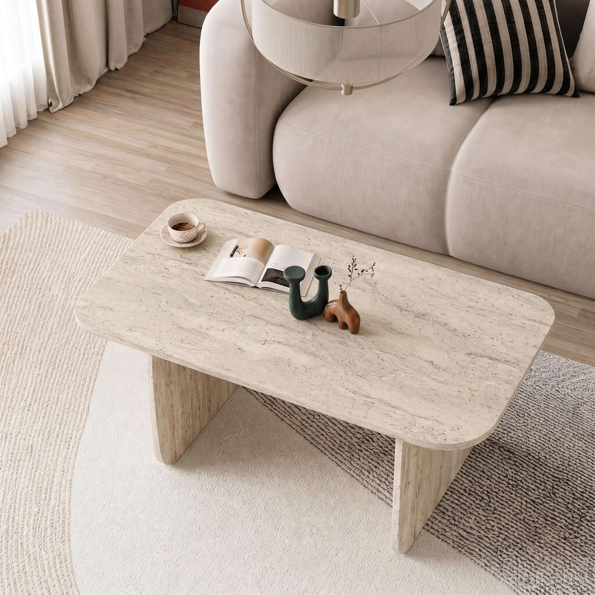 Rectangular travertine coffee table with rounded edges and thick legs