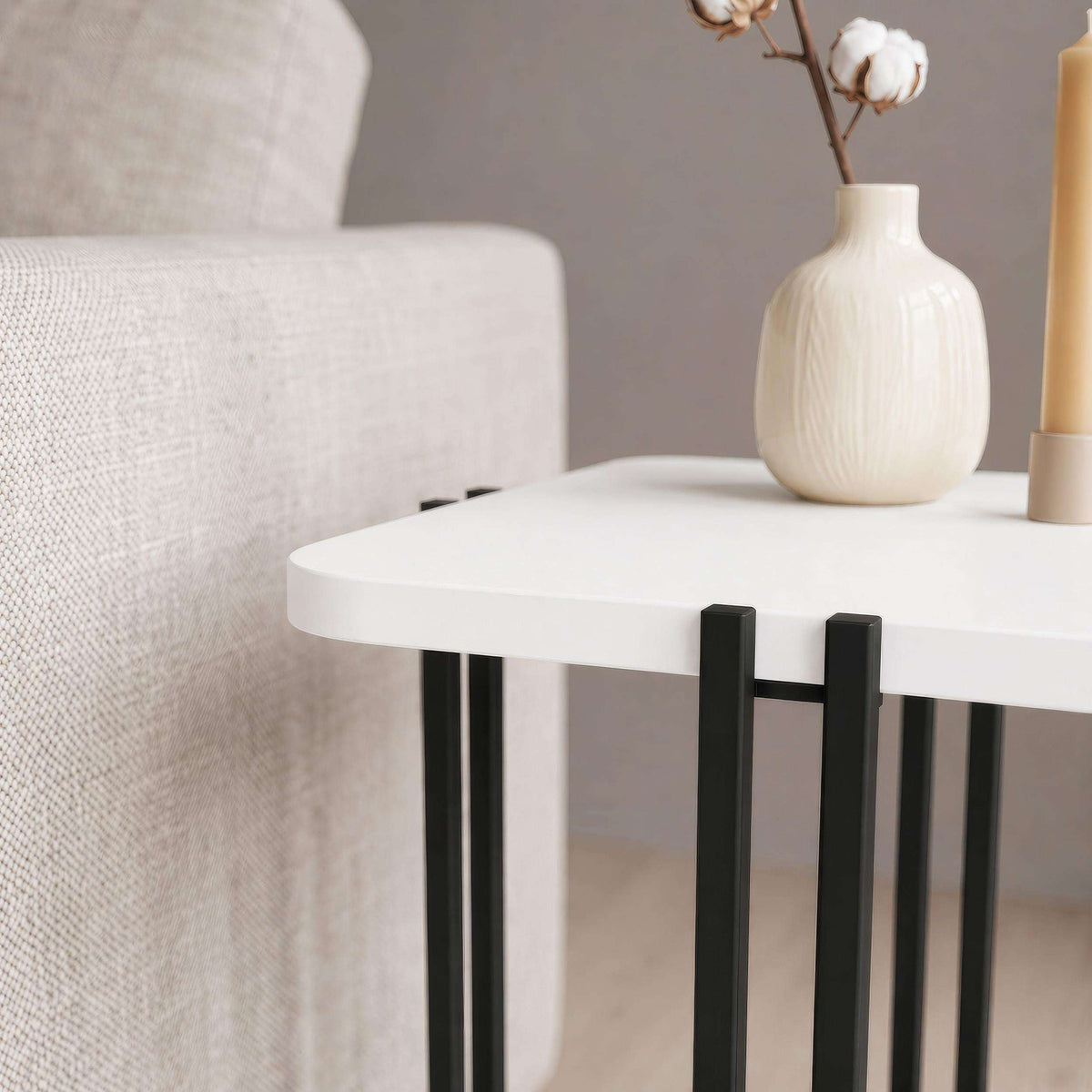 Two-tier side table with white top, black frame, and lower shelf.