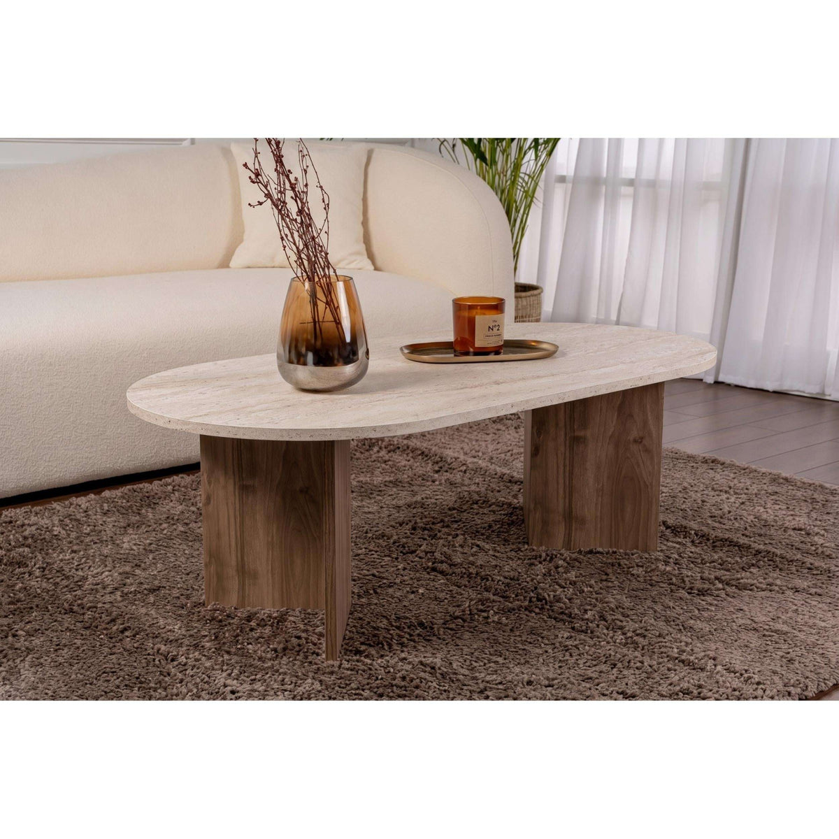 Oval coffee table with light stone tabletop and dark wood legs
