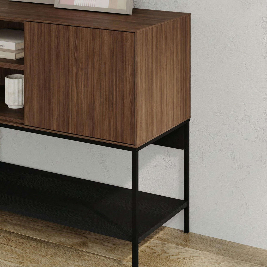 Modern console table with warm wood cabinet and black metal frame, open lower shelf.