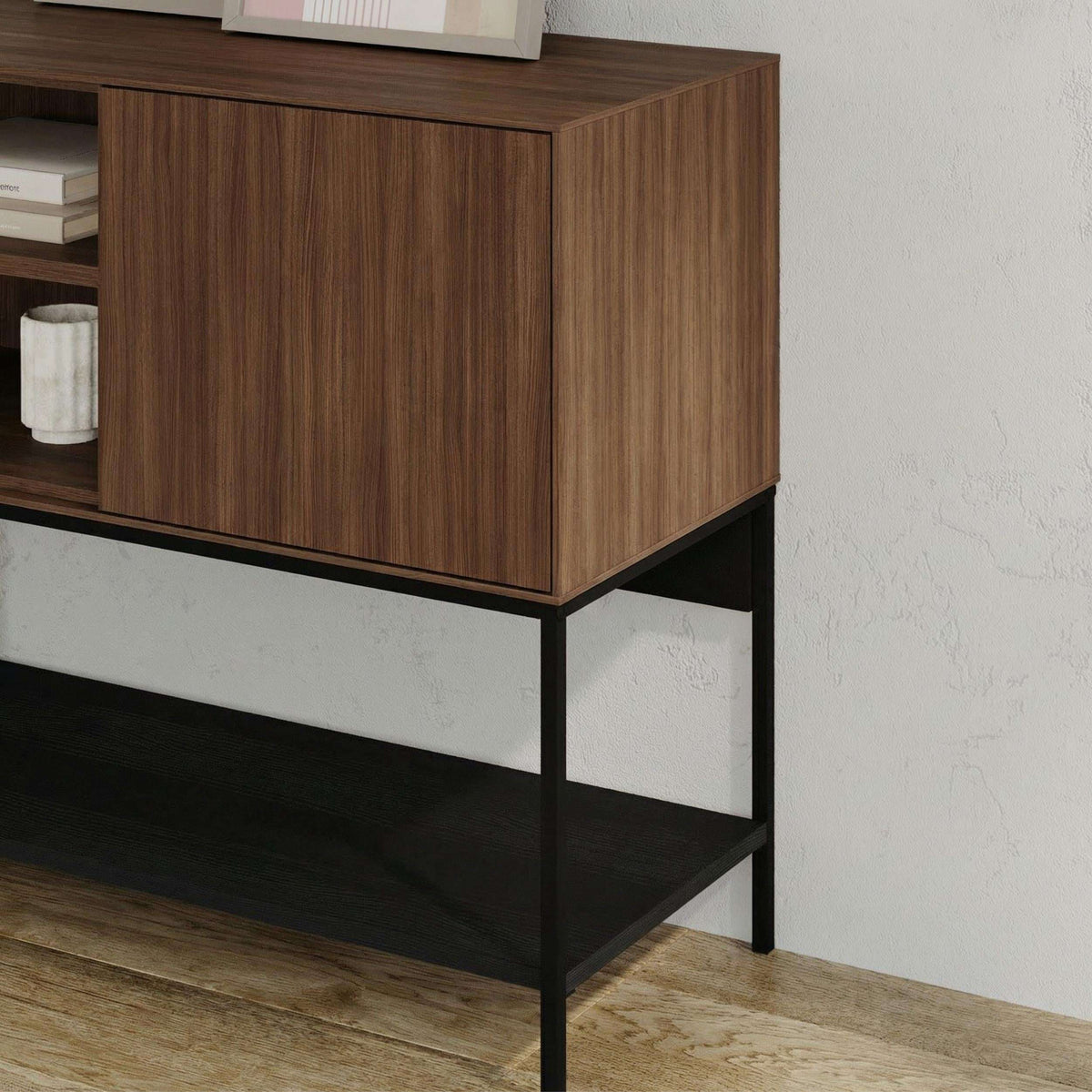 Modern console table with warm wood cabinet and black metal frame, open lower shelf.