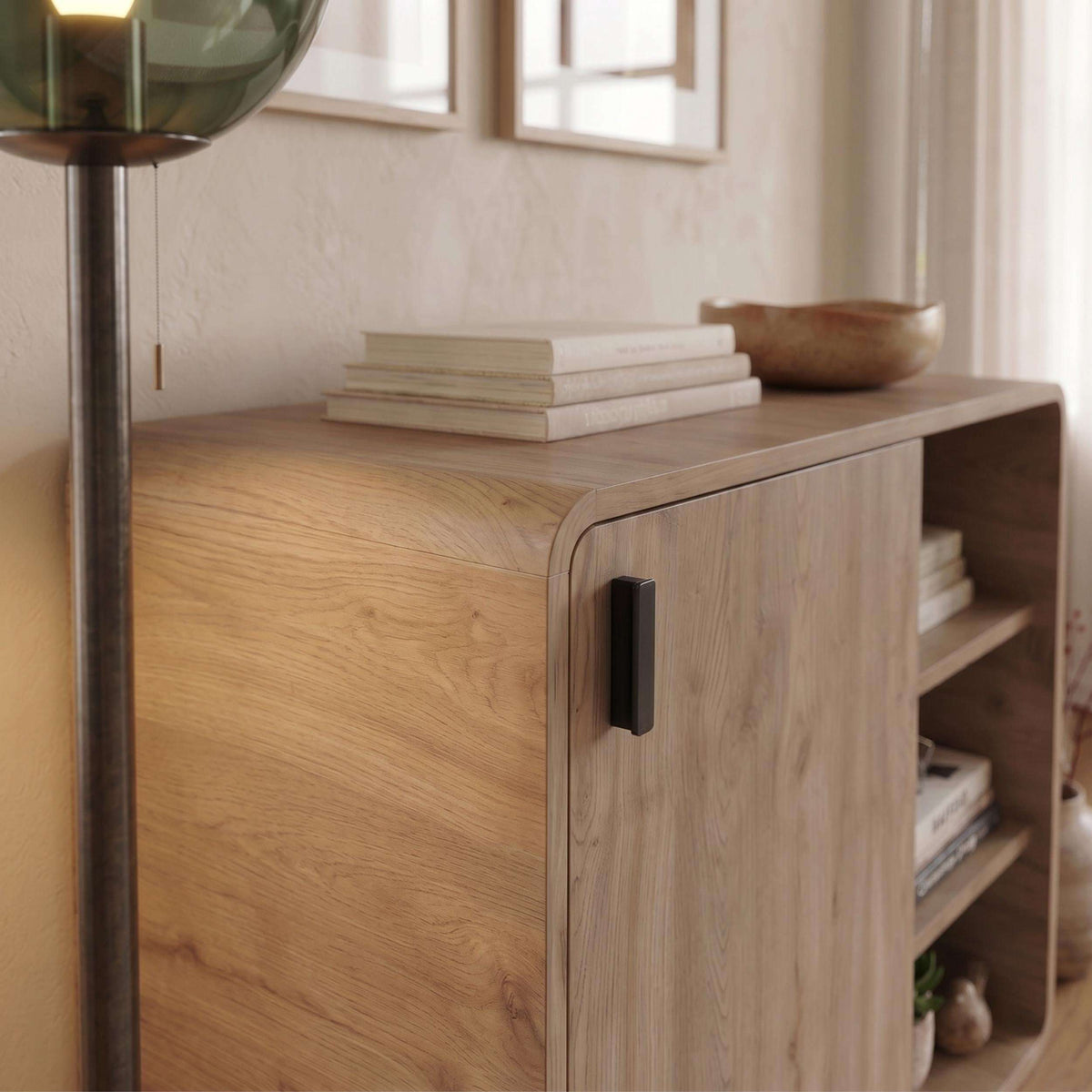 Natural oak sideboard with rounded front corner and handle on swing door