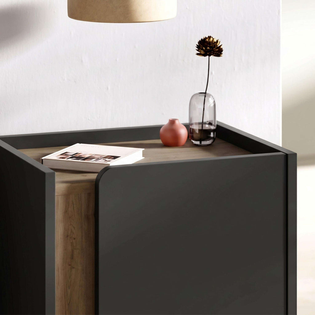 Modern bedside table close-up with closed door, dark finish and black metal legs