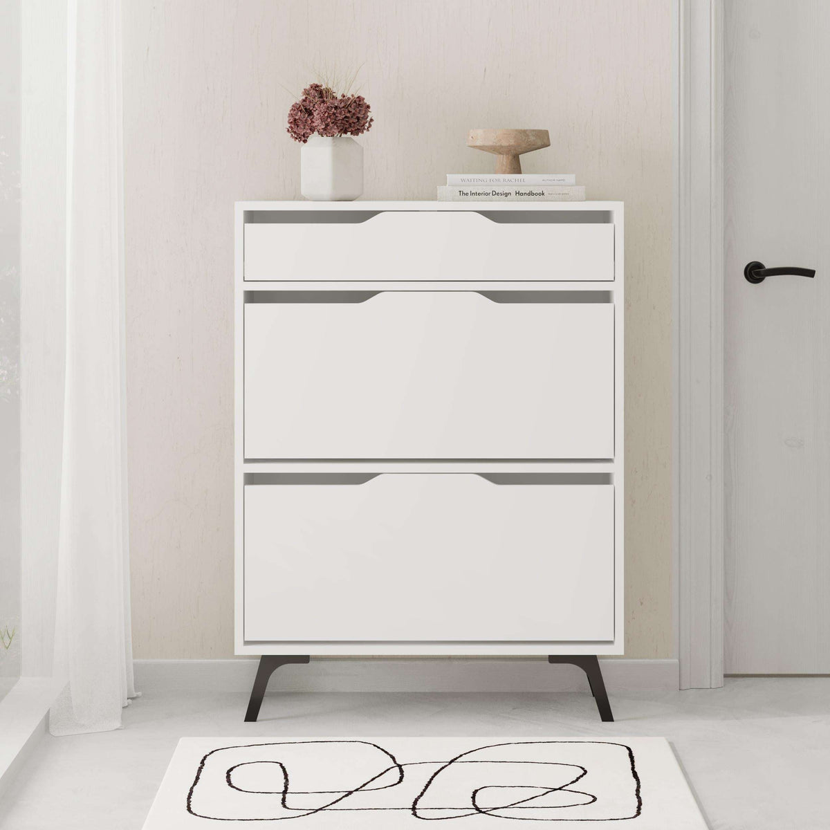 White shoe cabinet with two drawers and tapered legs, front view