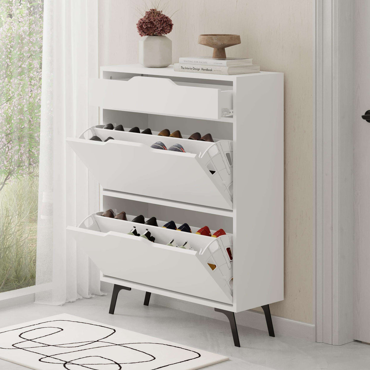 White shoe cabinet with open angled shelves holding several pairs of shoes