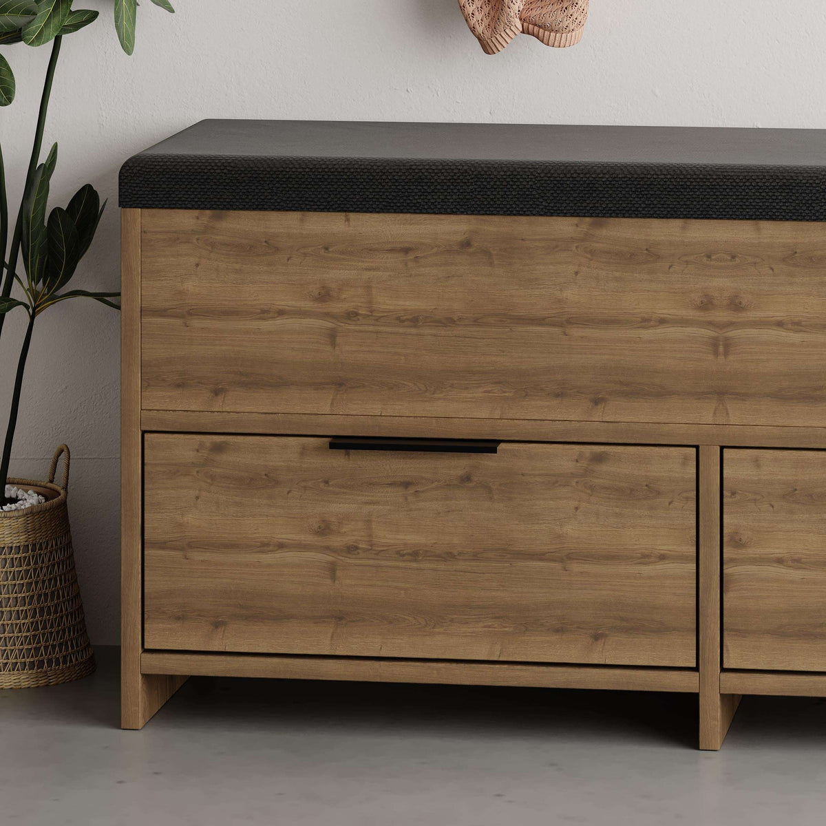 Modern shoe storage bench with dark fabric top and light wood drawer front