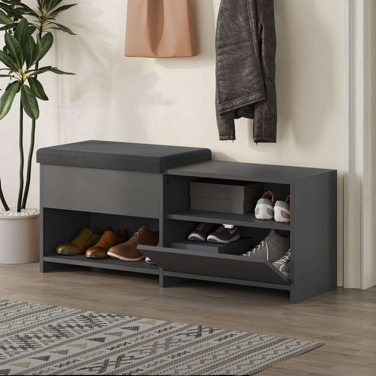 Dark gray shoe bench with cushioned top and open storage compartments for shoes.
