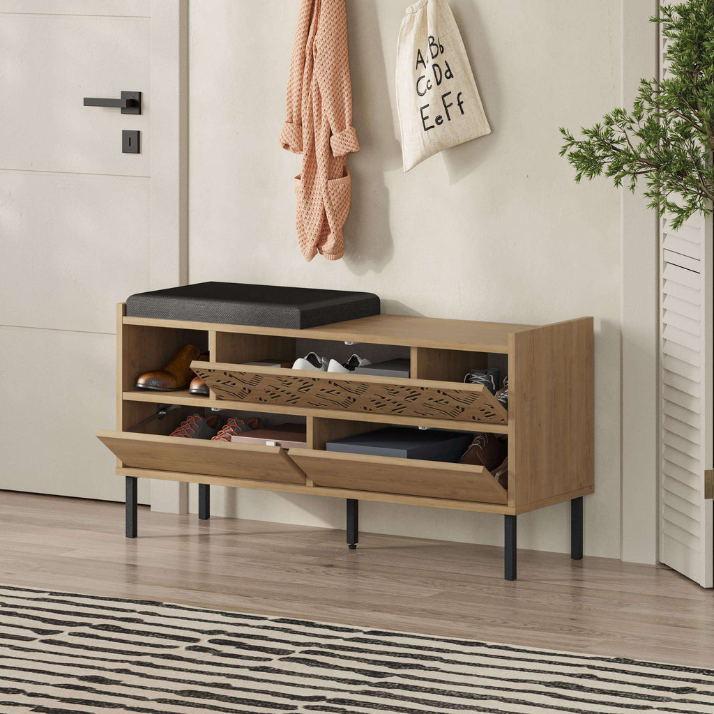 Shoe storage bench with black seat cushion, open shelves, and patterned cabinet fronts