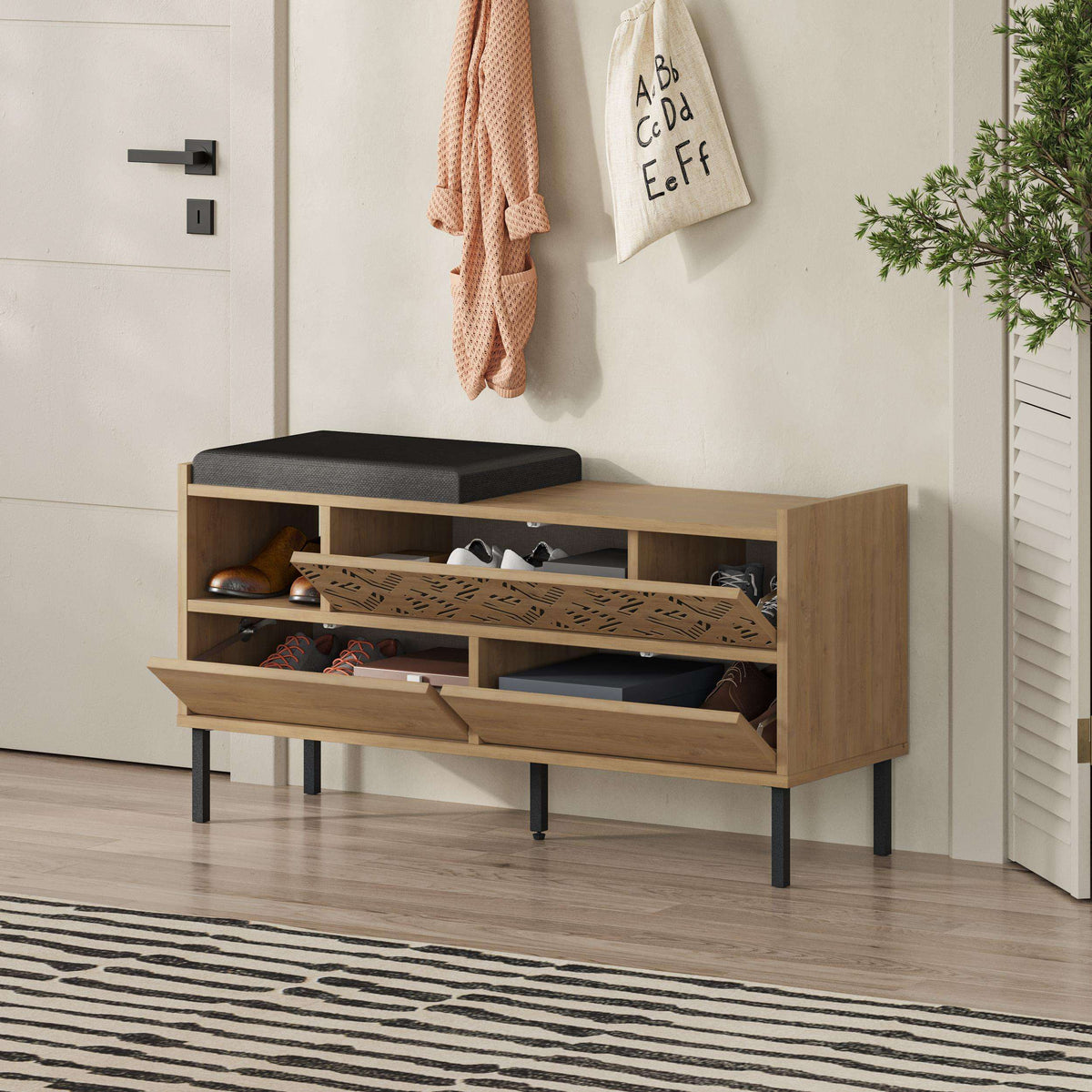 Shoe storage bench with black seat cushion, open shelves, and patterned cabinet fronts