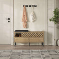 Shoe storage bench with dark top seat and open compartments, patterned drawer front