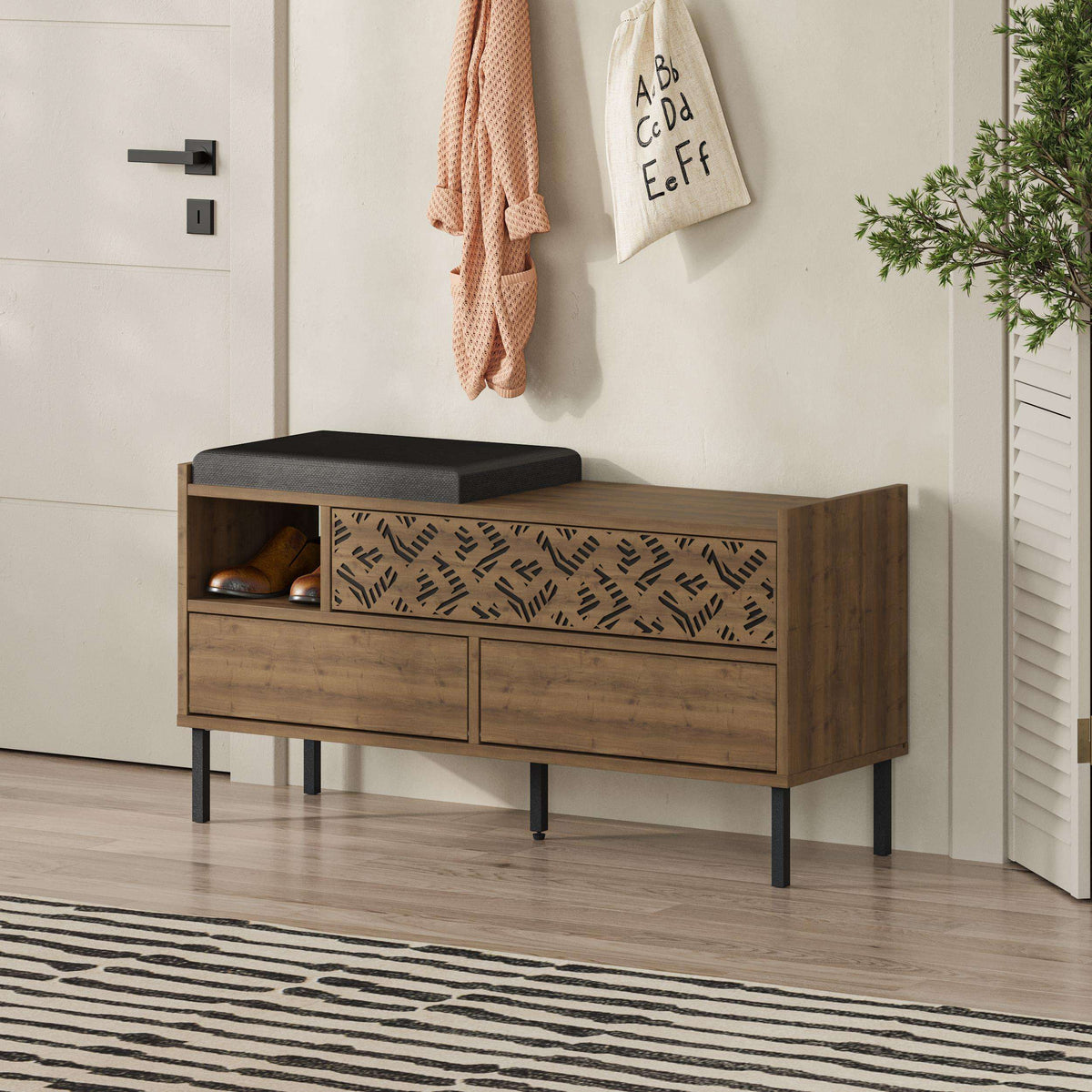 Wood shoe storage bench with black seat cushion and patterned cabinet panels