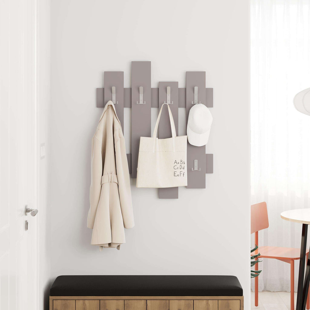 Light gray coat rack with wave panel hooks, holding coats, bags, and hat