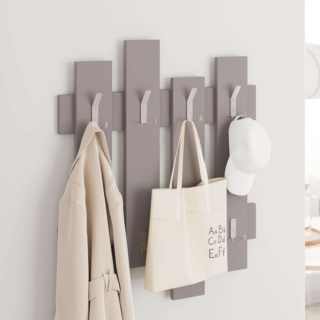 Light taupe wave wall coat rack with hooks, holding tote bag, coat, and cap