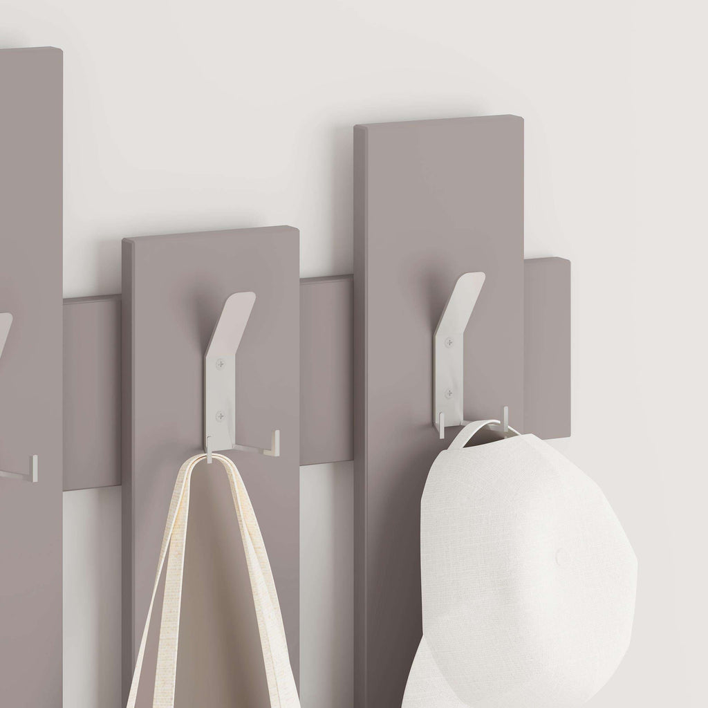 Light mocha coat rack with wave panel hooks, holding a bag and garment