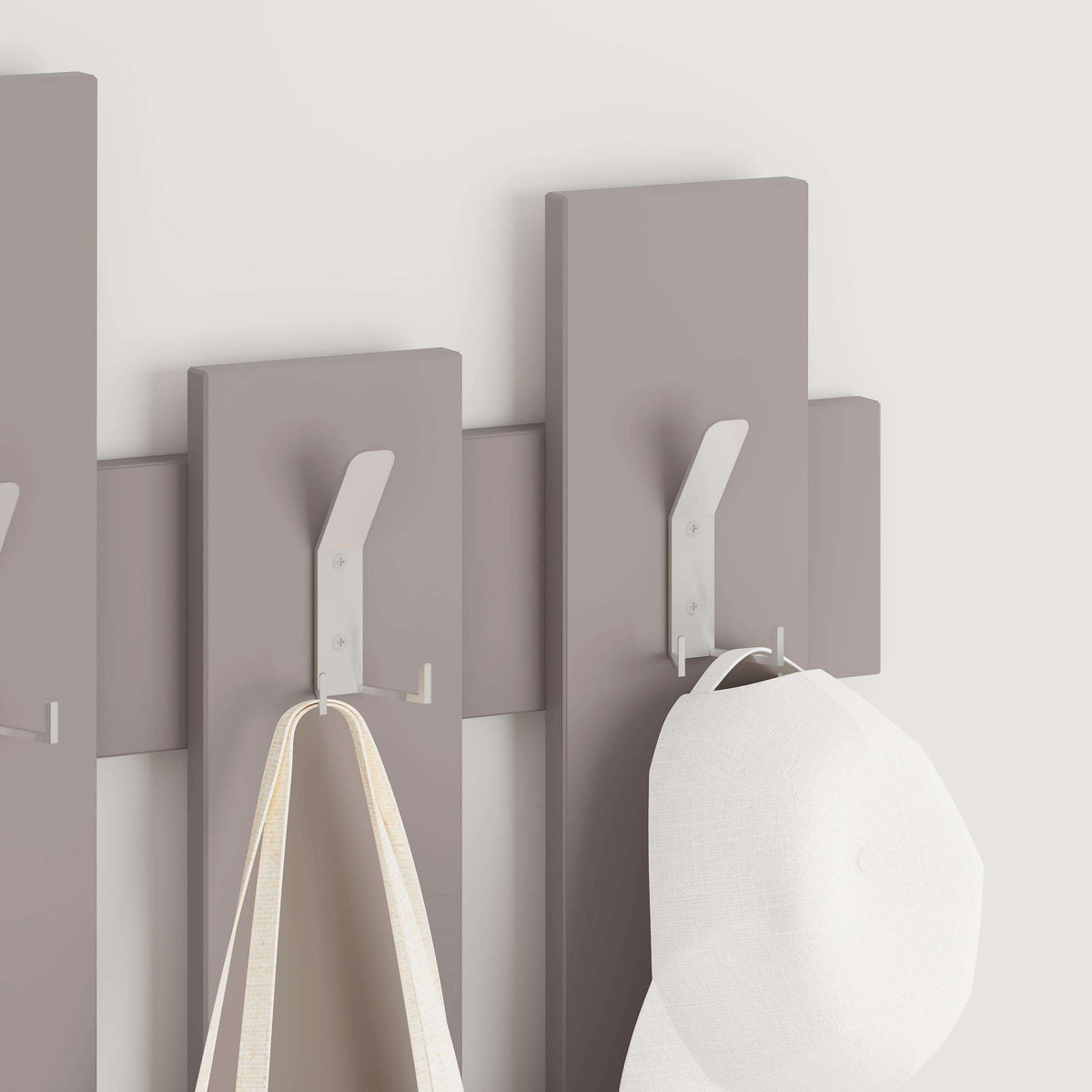 Light mocha coat rack with wave panel hooks, holding a bag and garment