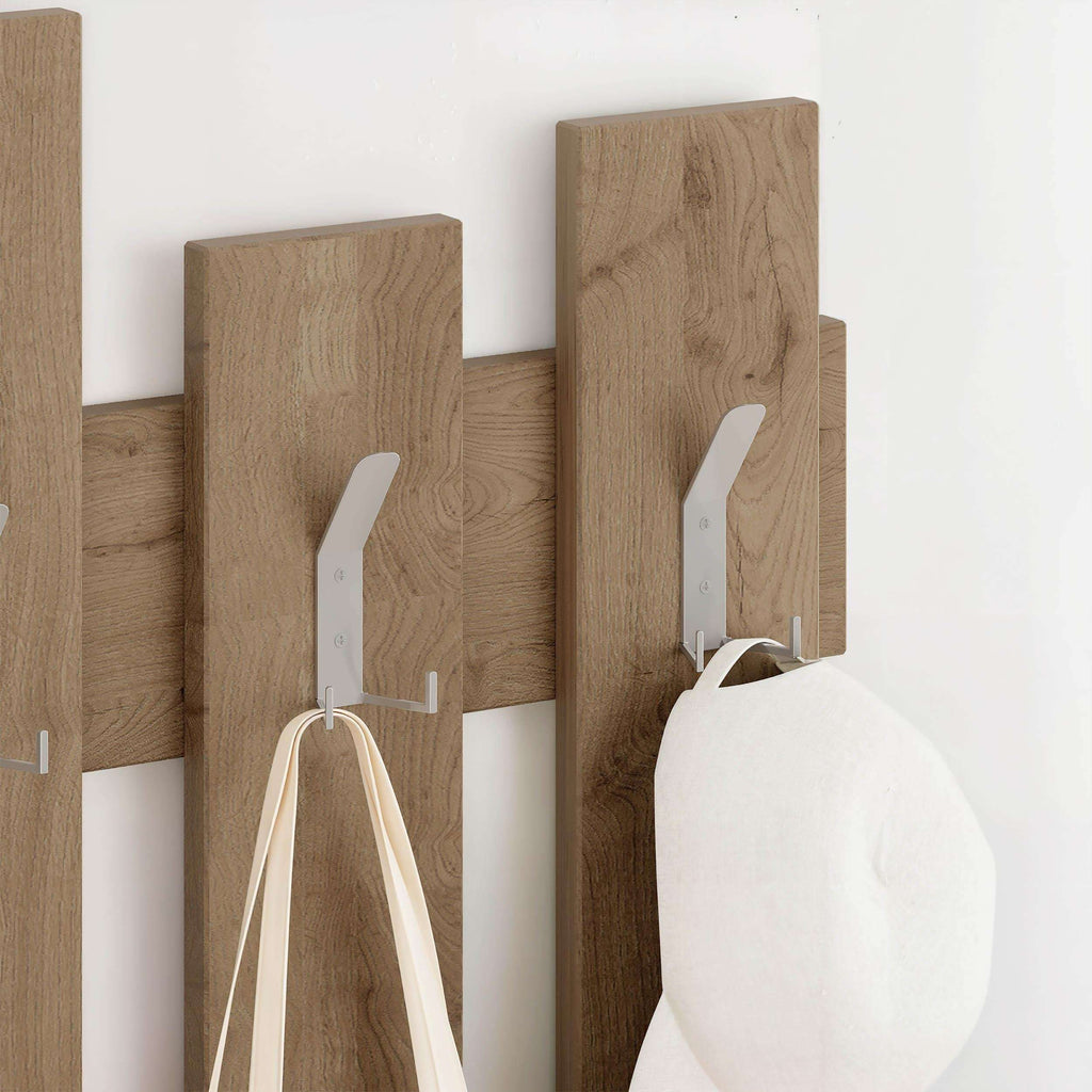 Wooden wall coat rack with white hooks holding tote bags