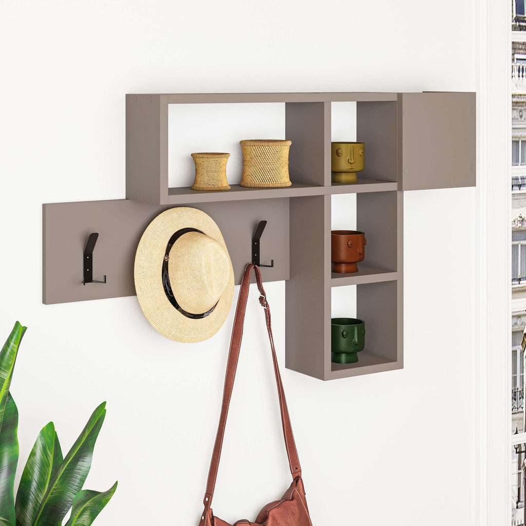 Wall-mounted game hanger with dark shelves, open cubbies, and three black coat hooks; hat and bag.