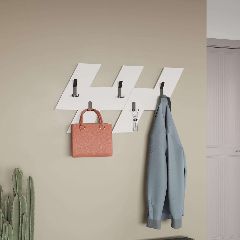 Wall-mounted coat hanger set with light wood panels and black hooks holding a coat