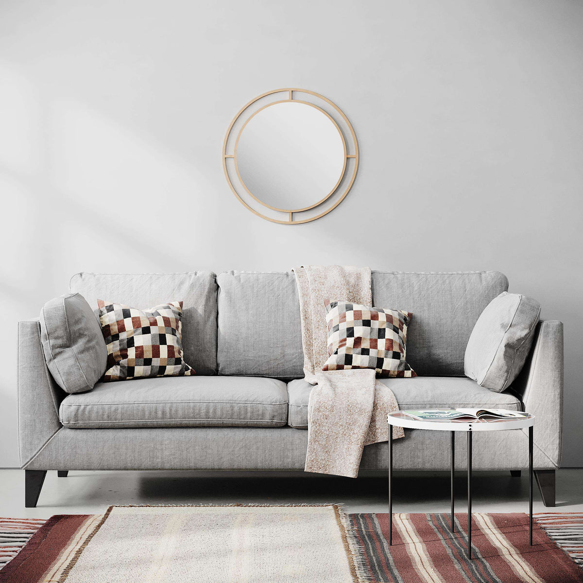 Wall mirror with gold round frame and slim geometric bars around the reflective center.