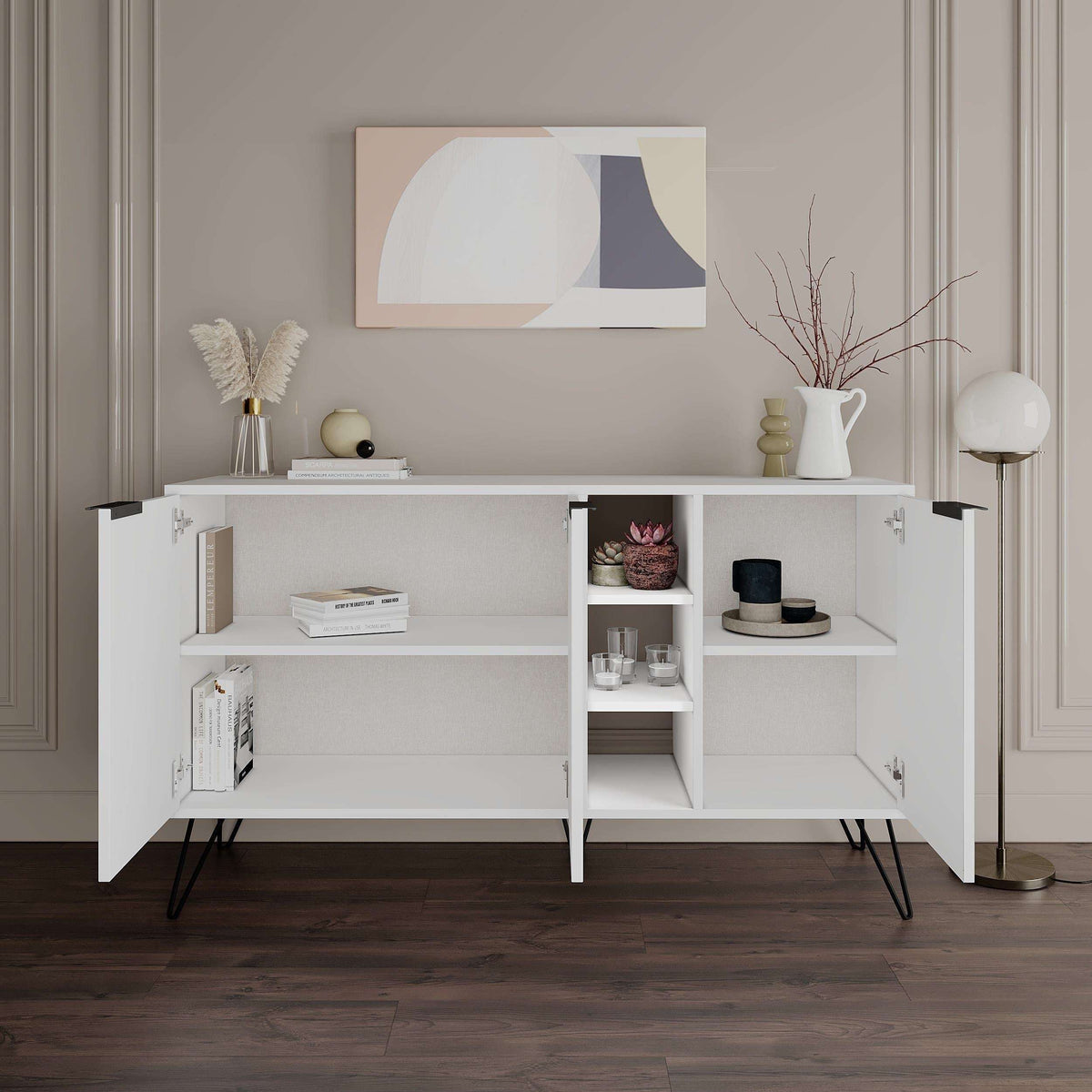 Modern white sideboard console with two doors, open shelving center, slim black legs.