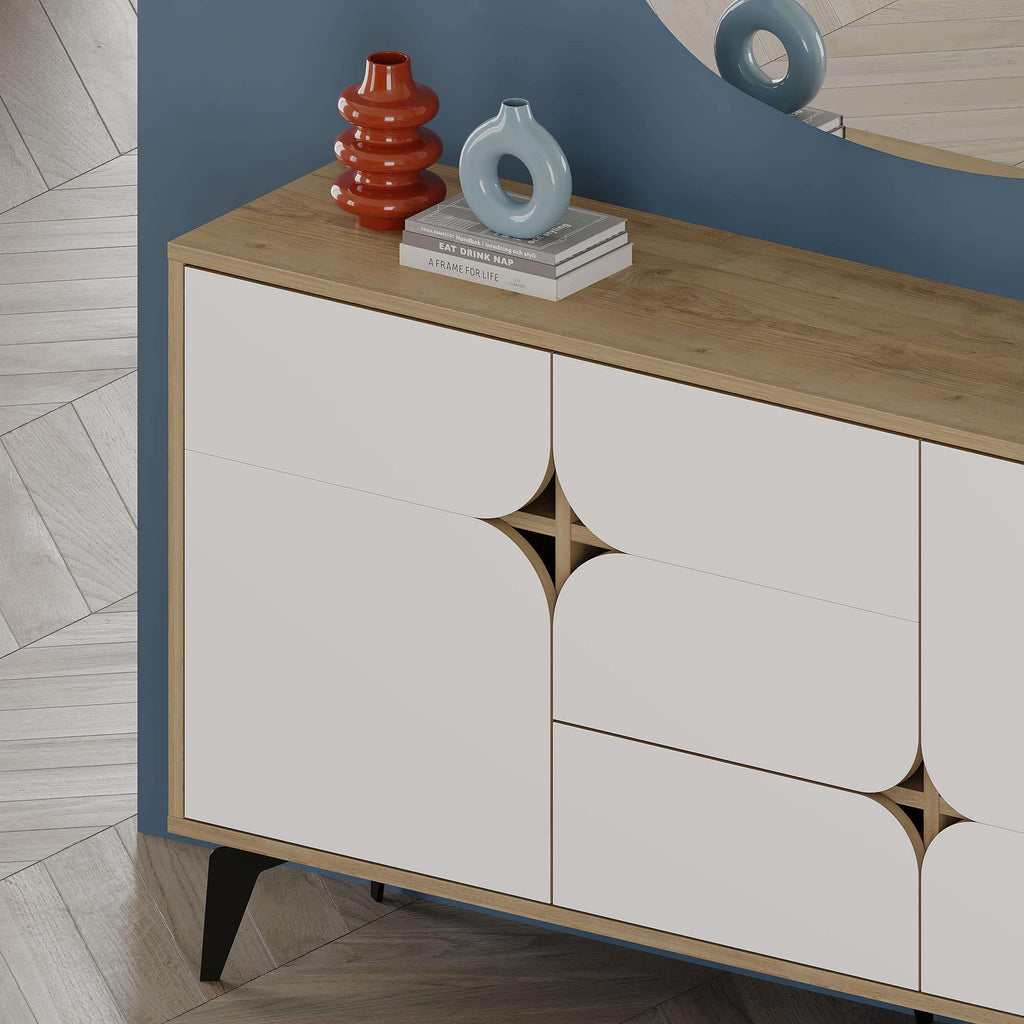 Sideboard with wood top, white three-panel doors, and sculpted cutout motifs