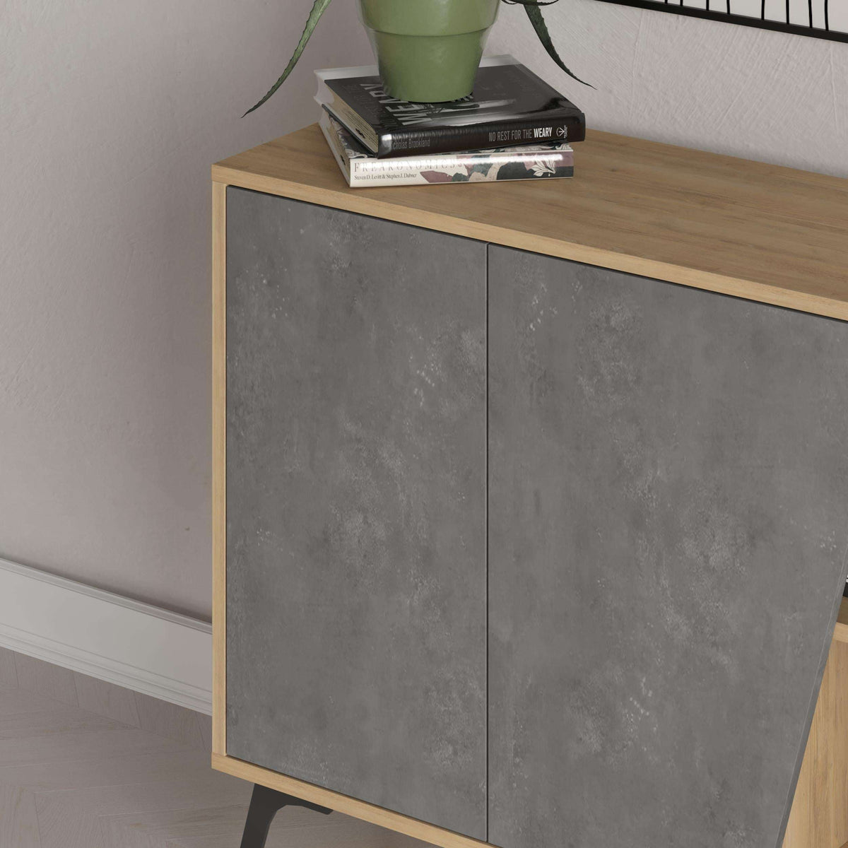 Close-up of two-door grey cabinet front with oak trim and top edge, on angled legs