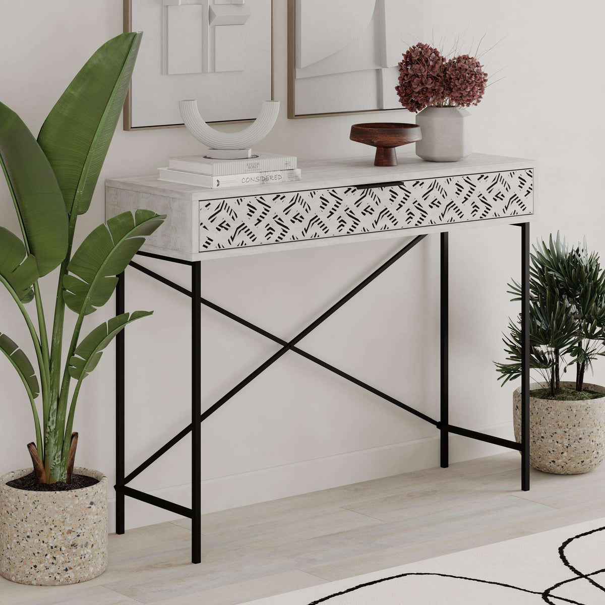 Ancient white console table with patterned drawer and black metal X-frame
