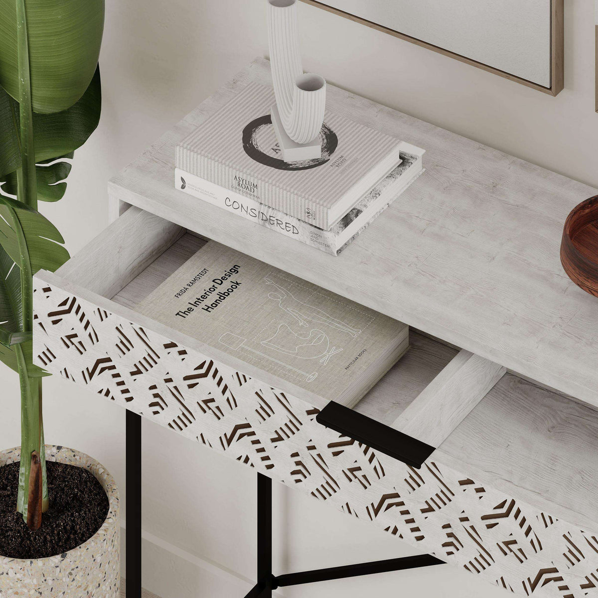 Ancient white console drawer with patterned front and black metal frame