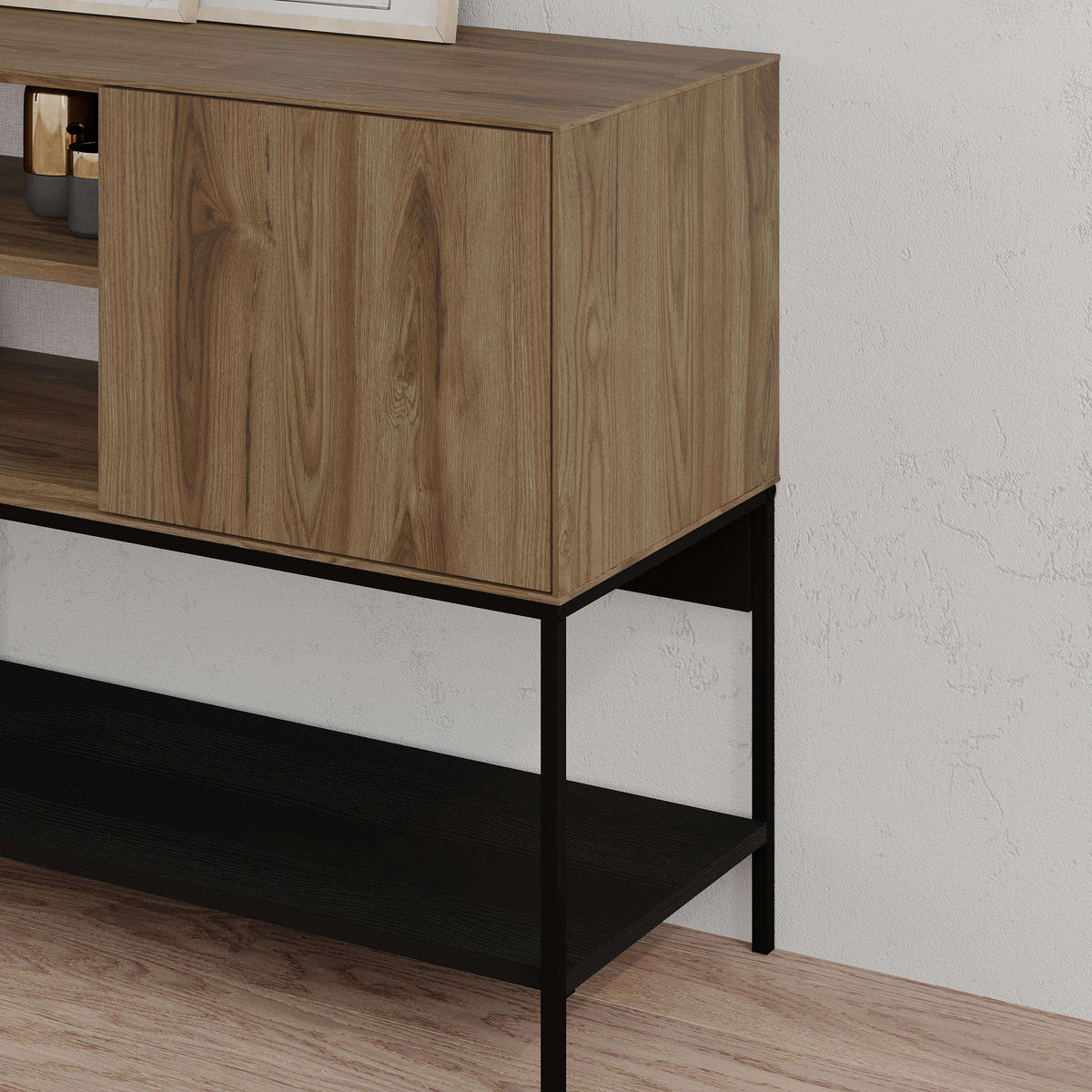 Modern console table corner with warm wood cabinet doors and black metal frame