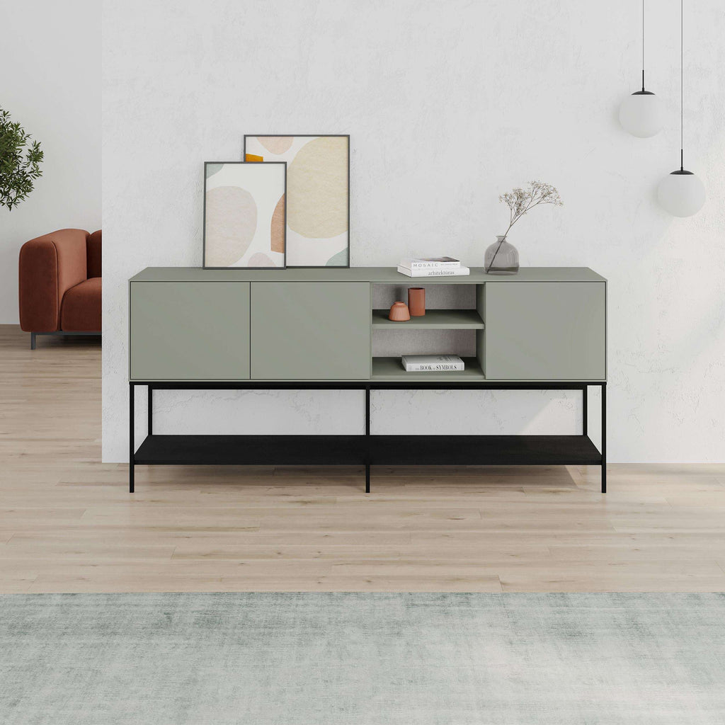 Modern console table with sage-gray cabinet fronts, black metal frame, and open shelves