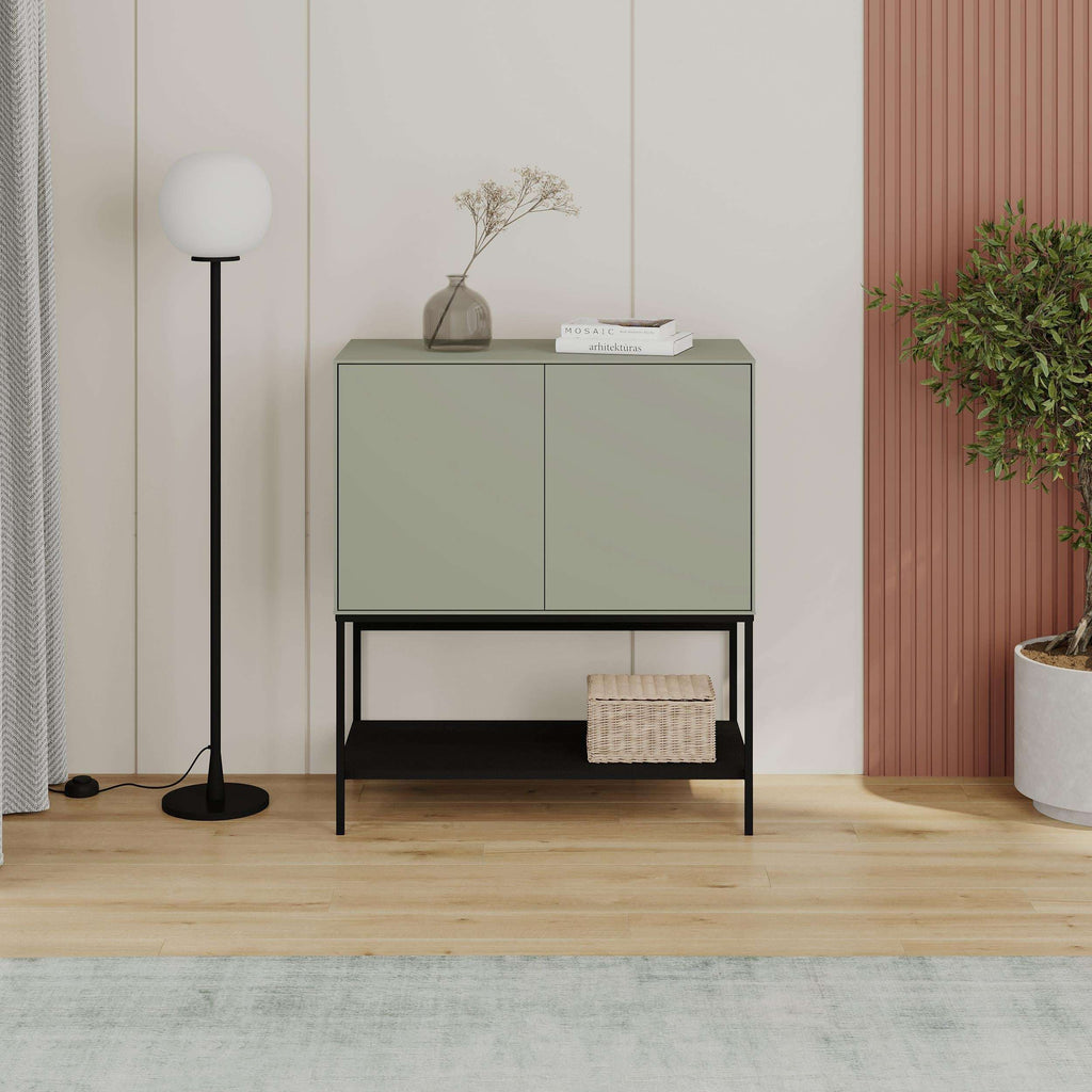 Sage green console table with two cabinet doors, black frame, and open lower shelf