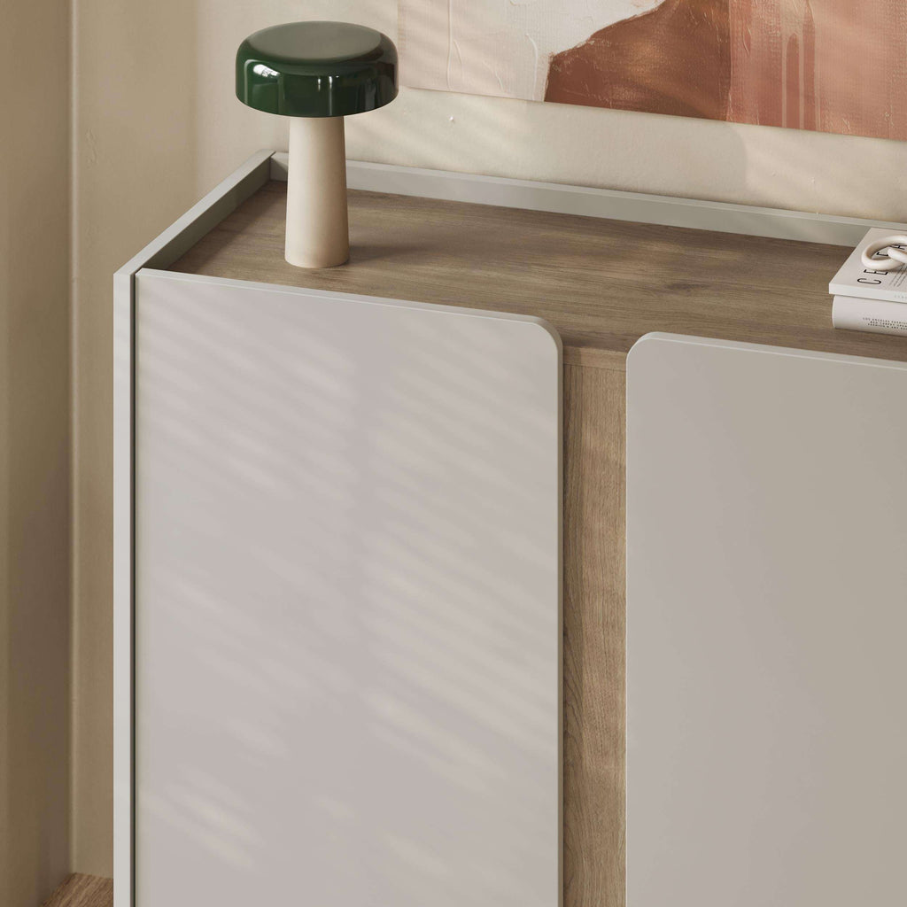 Light oak sideboard with two panel doors, open shelf, and slim metal legs