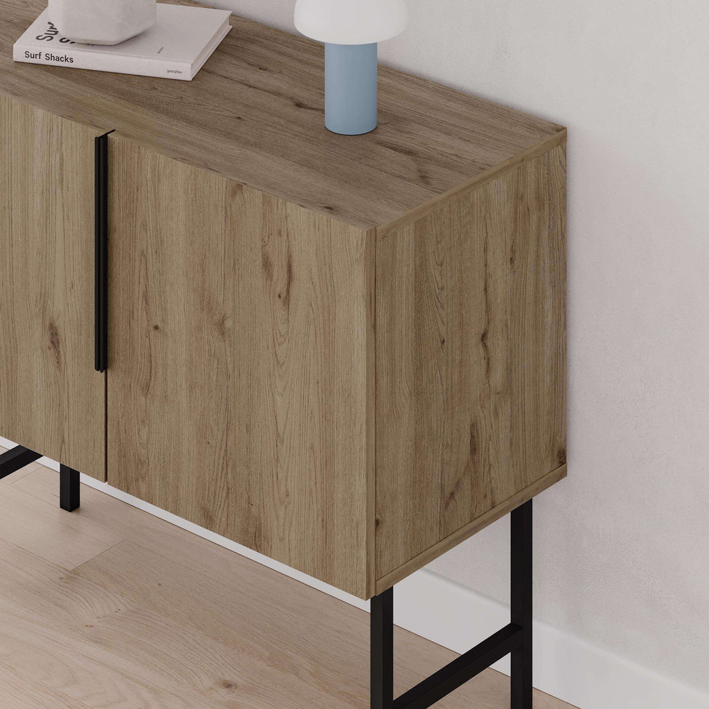 Natural oak 2-door console cabinet corner view with black legs and door handle.