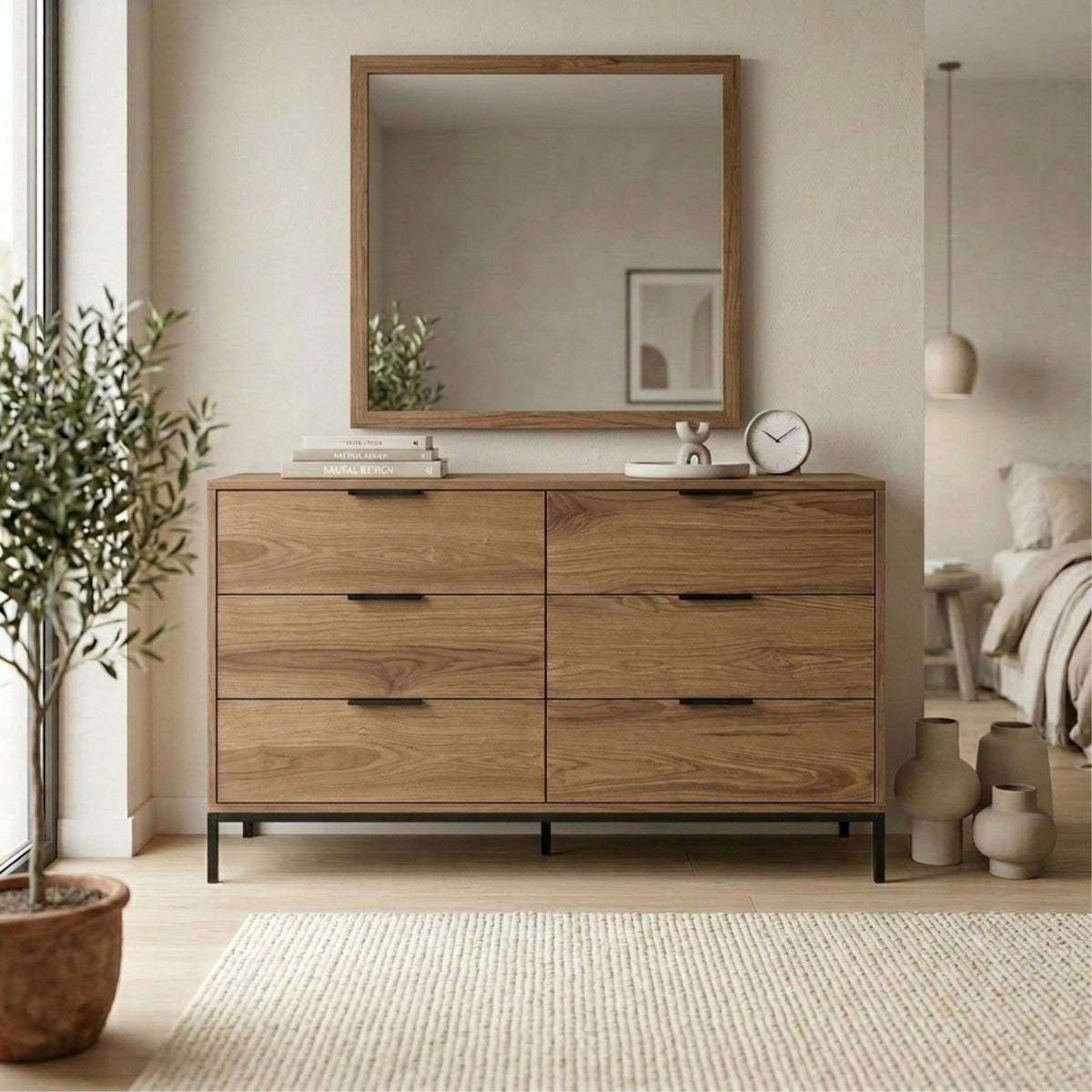 Whiskey oak 6-drawer chest with dark handles and wall mirror above