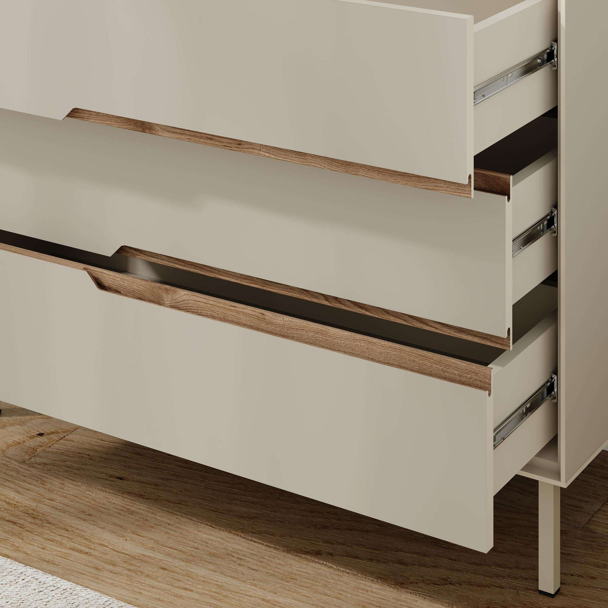 Close-up of modern chest of drawers: open drawers, wood bar handles, metal drawer tracks