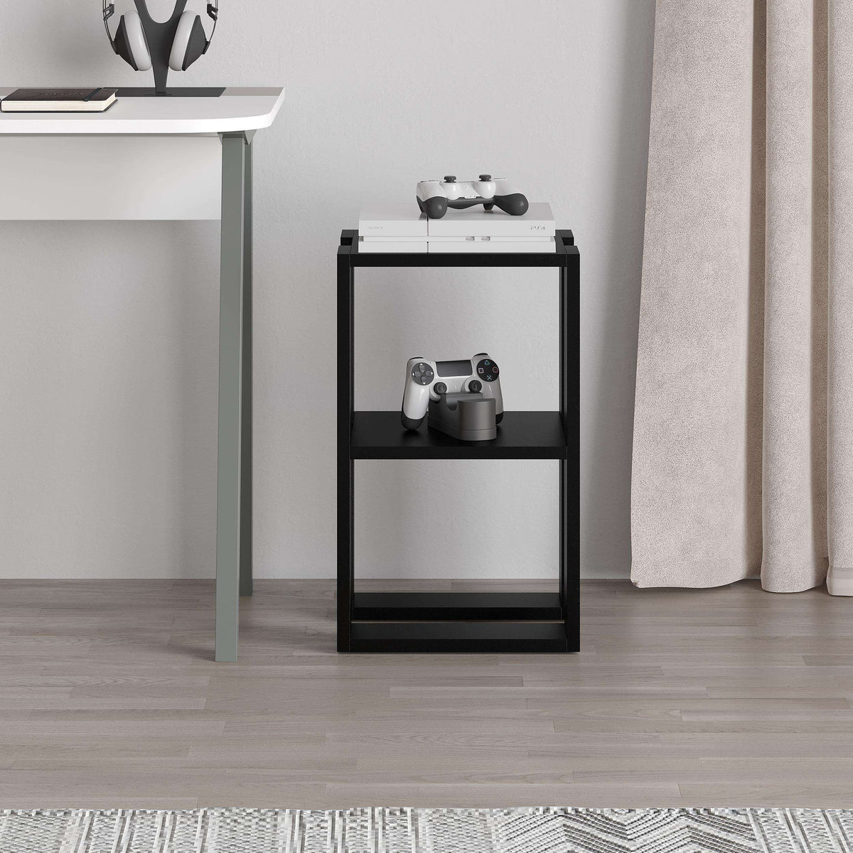 Black bedside table with console controller and speaker on top, two open shelves