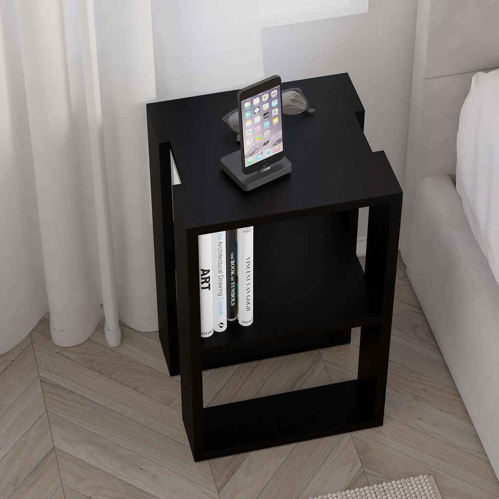 Black bedside table with phone dock on top and books on the lower shelf