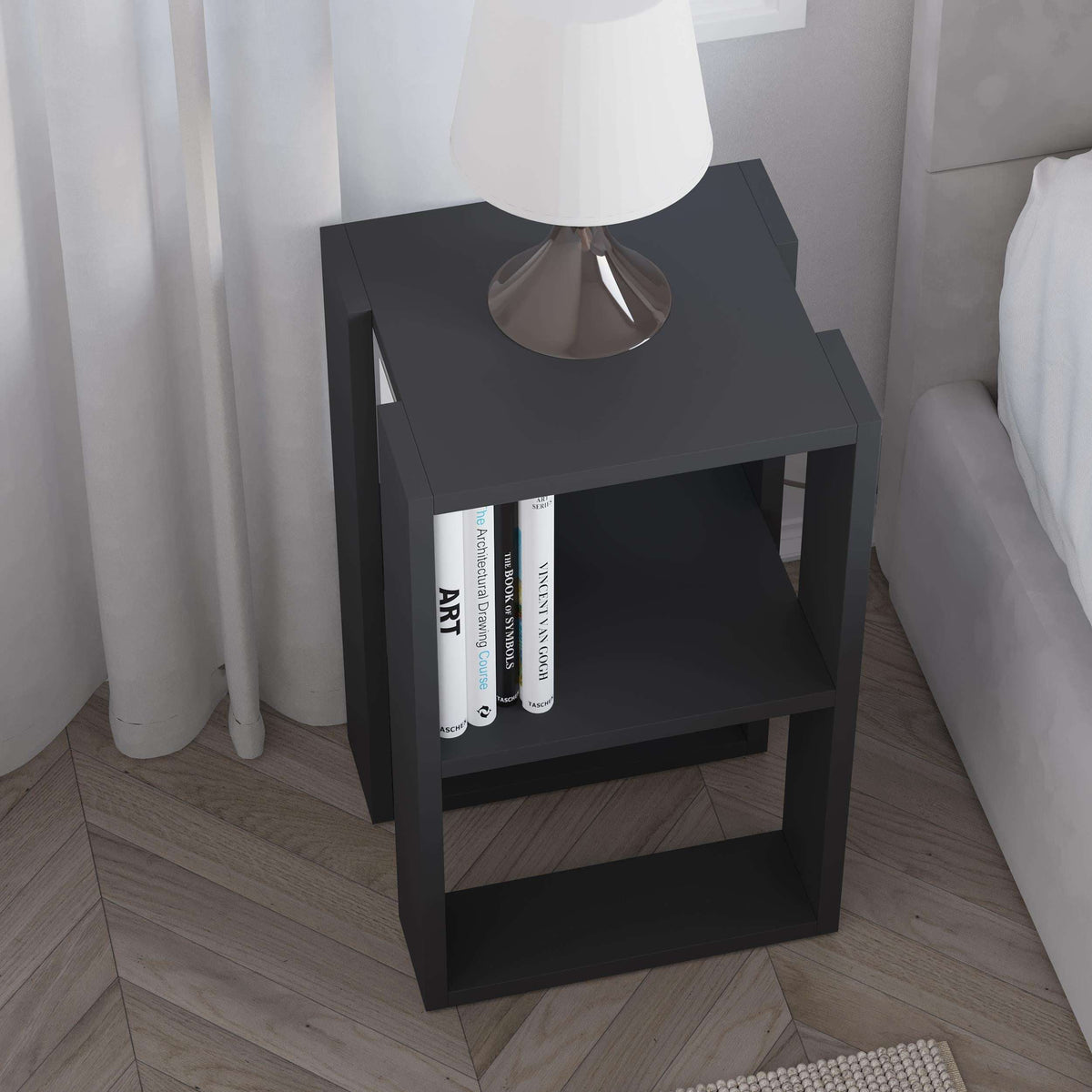 Black bedside table with two open shelves and flat top for a table lamp