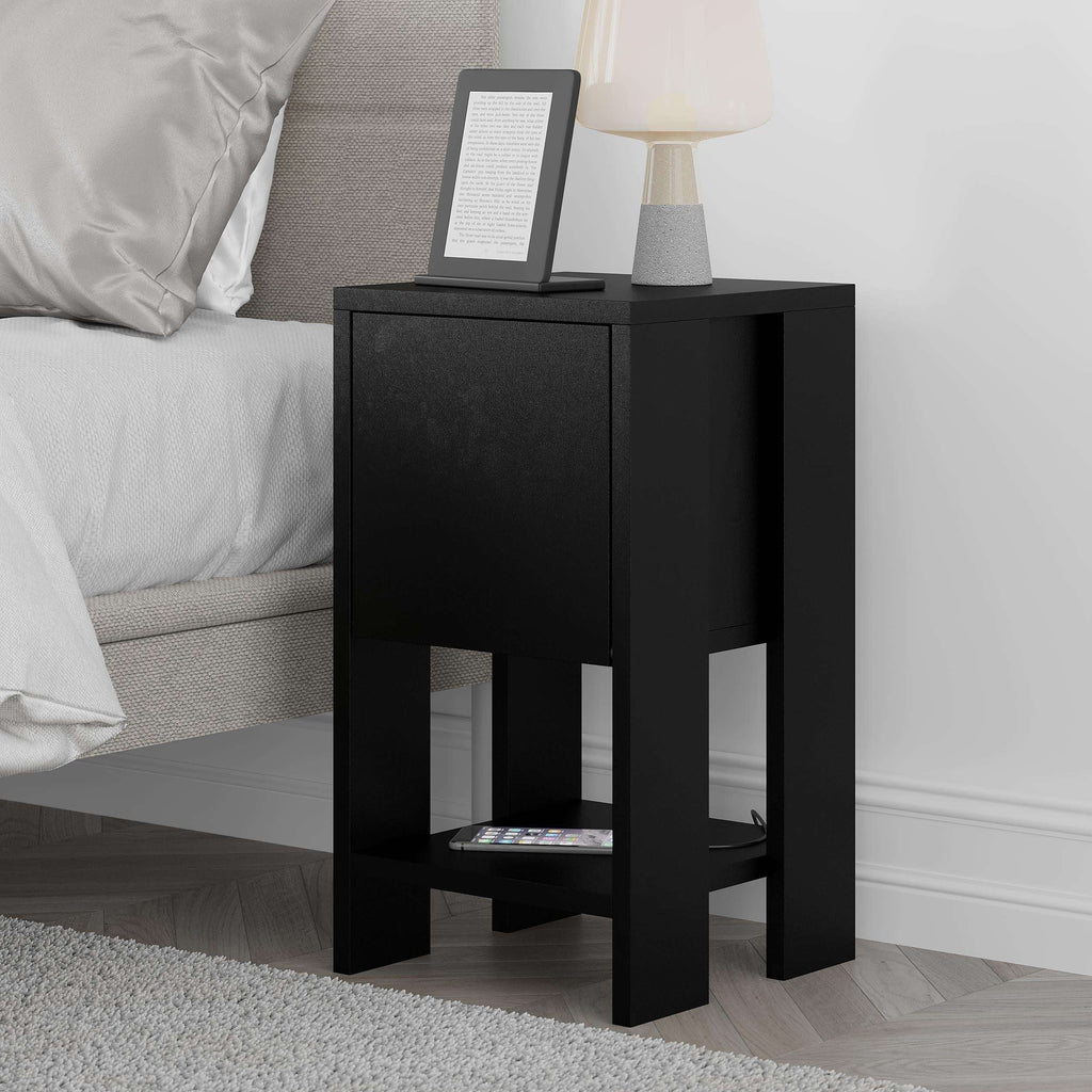 Black bedside table with cabinet door and open lower shelf, tablet displayed on top.