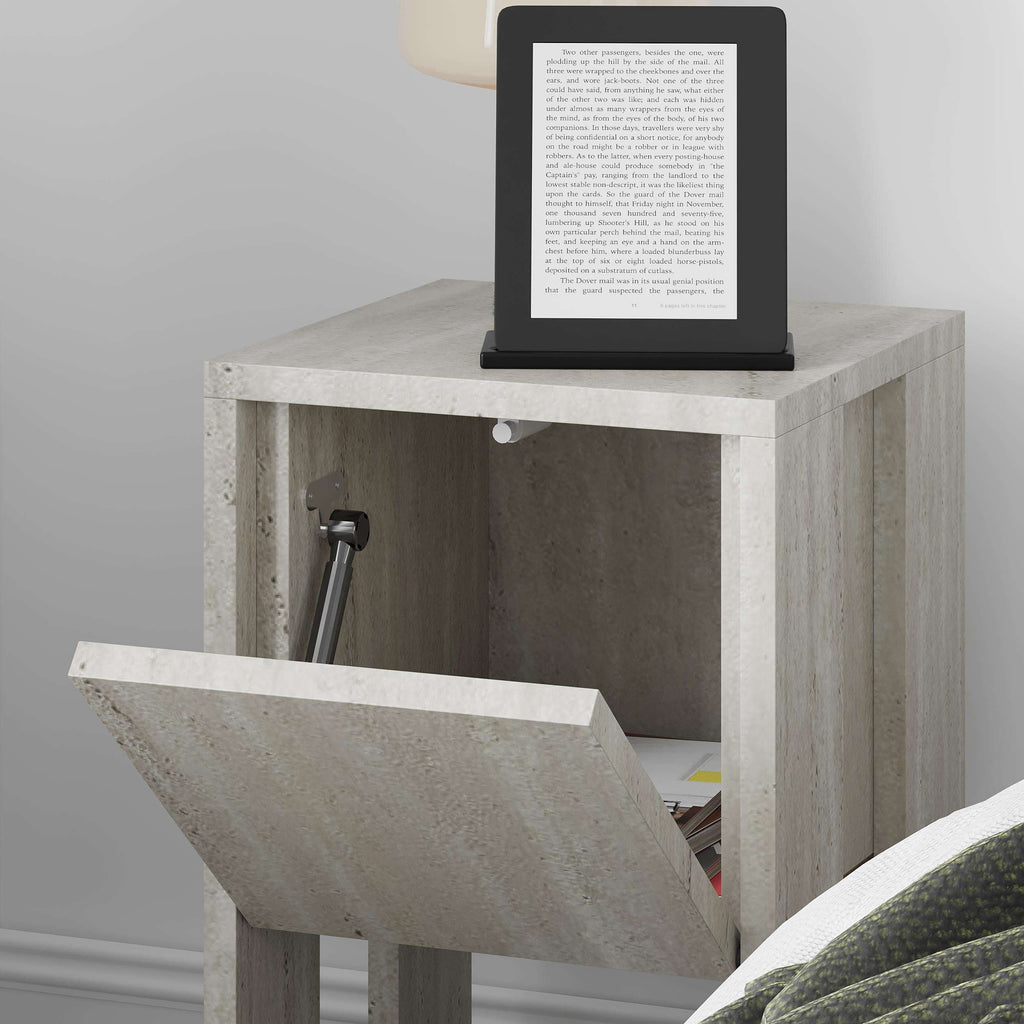 Light travertine bedside table with flip-open drawer panel and open storage, 30cm wide.